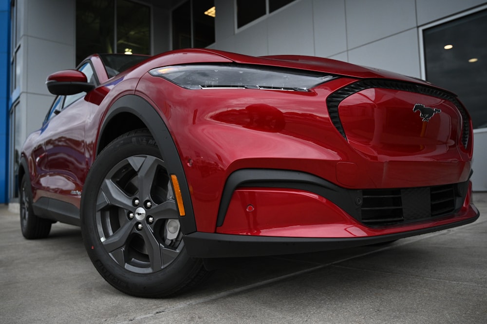 a red sports car parked in front of a building