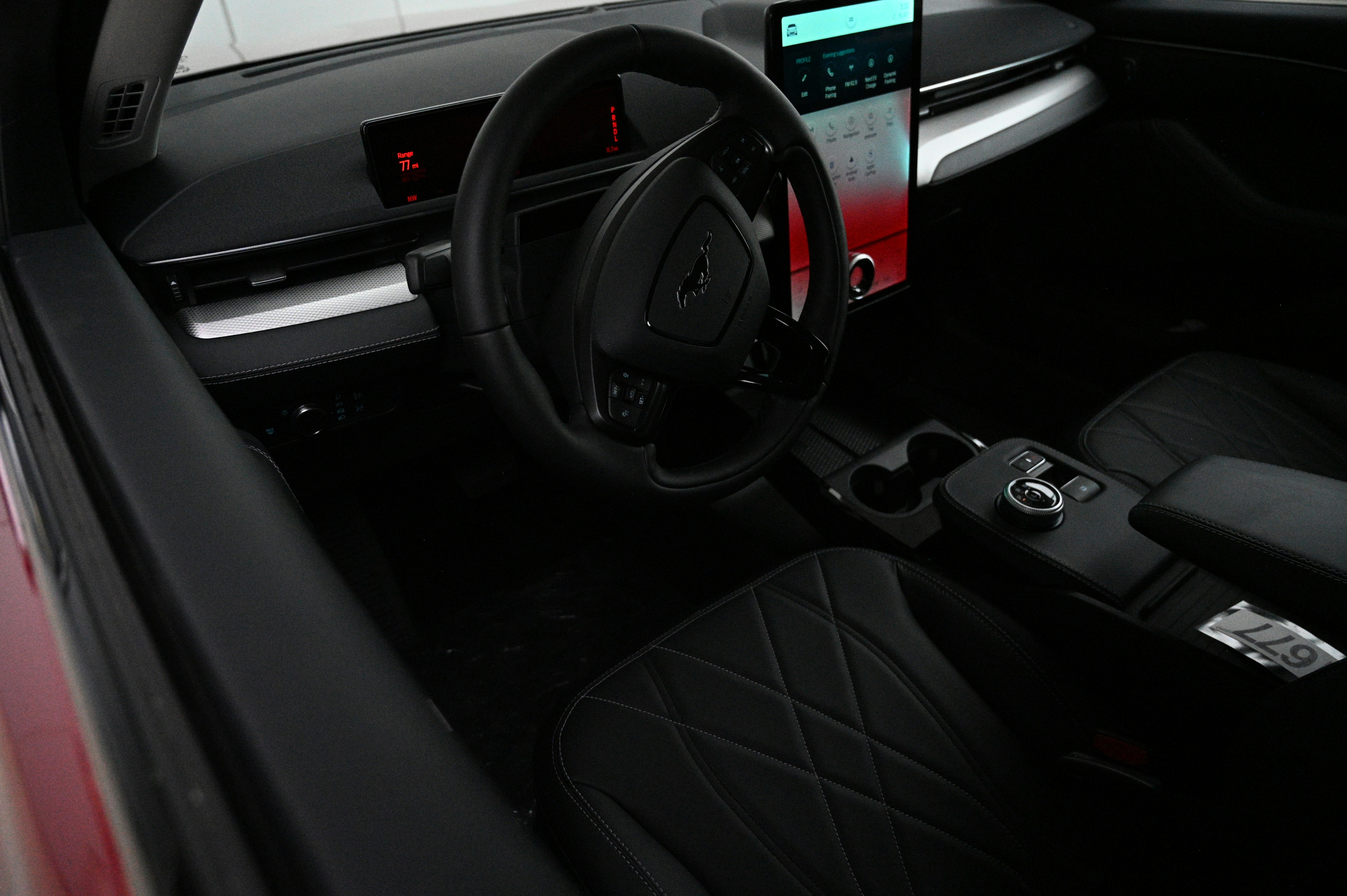 Modern electric sedan interior with digital dashboard and infotainment screen