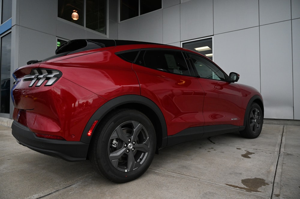 a red car parked in front of a building