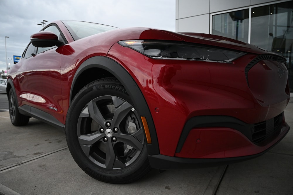 a red sports car parked in front of a building