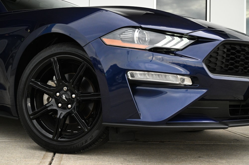 the front end of a blue mustang car
