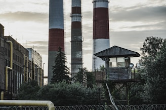 a factory with smoke stacks in the background