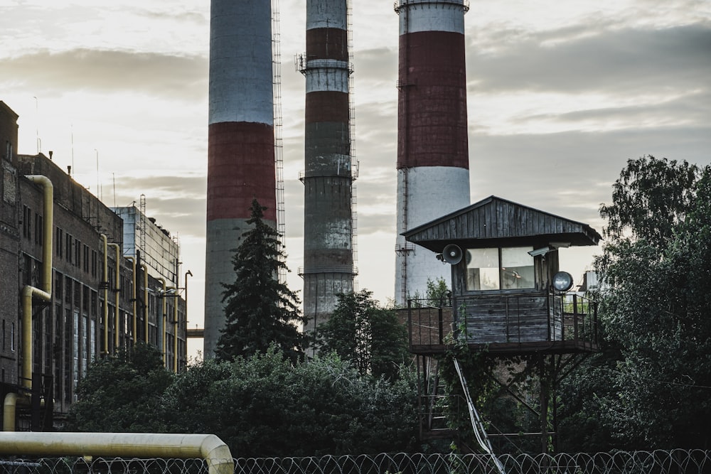 a factory with smoke stacks in the background