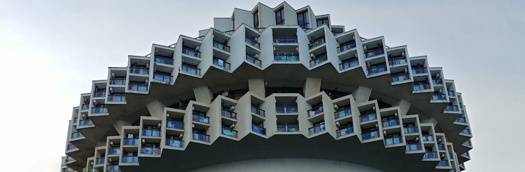 a very tall building with many windows and balconies,