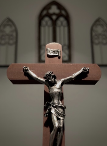 a cross with a statue of jesus on it