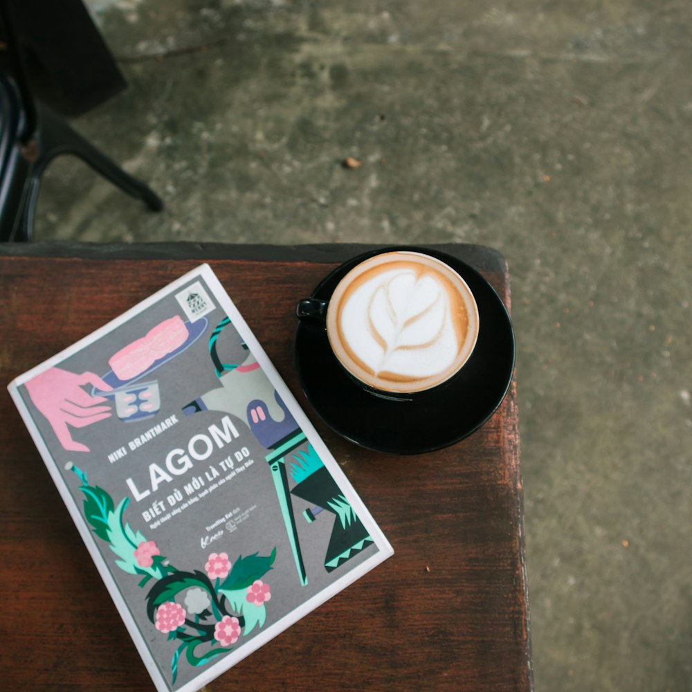 a cup of coffee and a book on a table