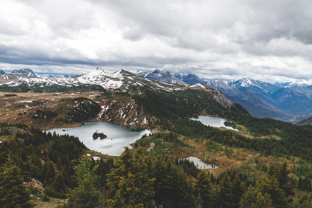 a view of a mountain range with a lake in the foreground