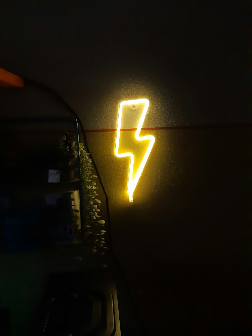 a neon sign that is on the side of a wall