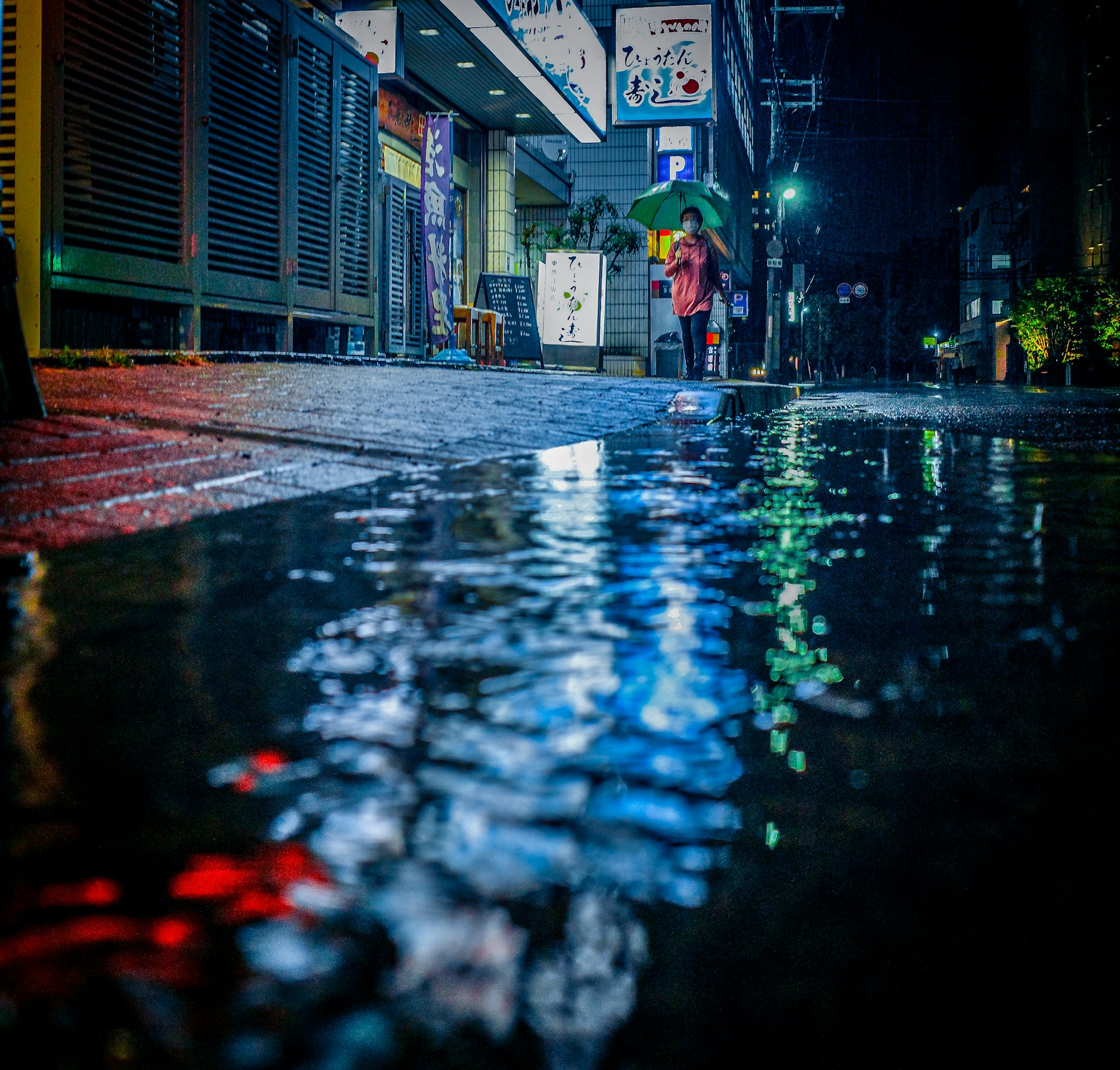 a person walking down a street with an umbrella