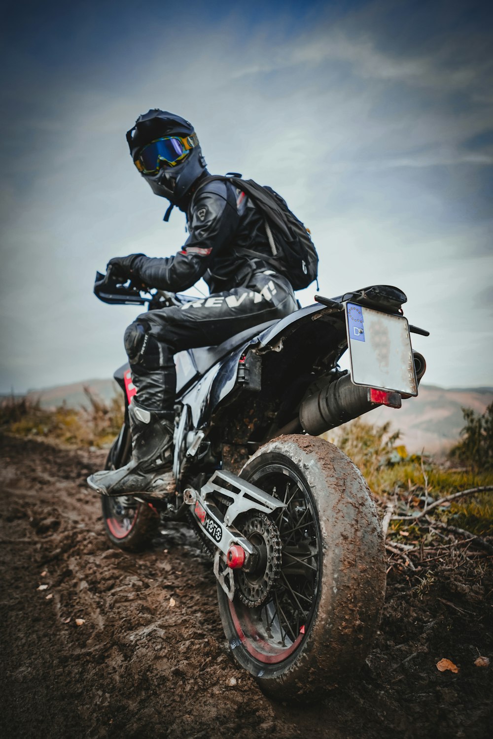 a man riding on the back of a dirt bike
