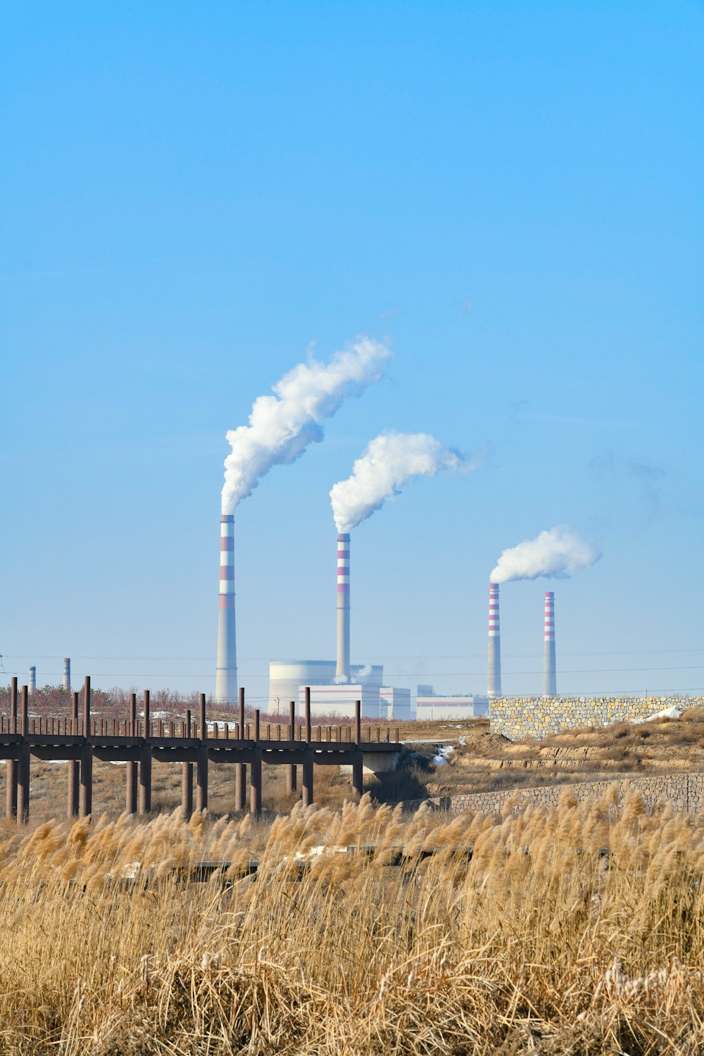 a factory with smoke coming out of it's stacks