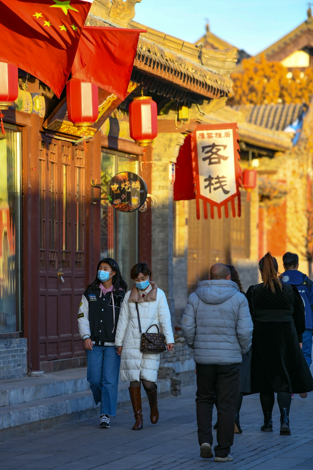 a group of people walking down a street