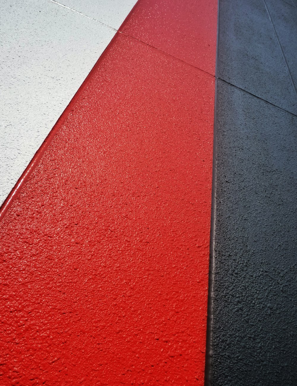 a close up of a red and a black side walk