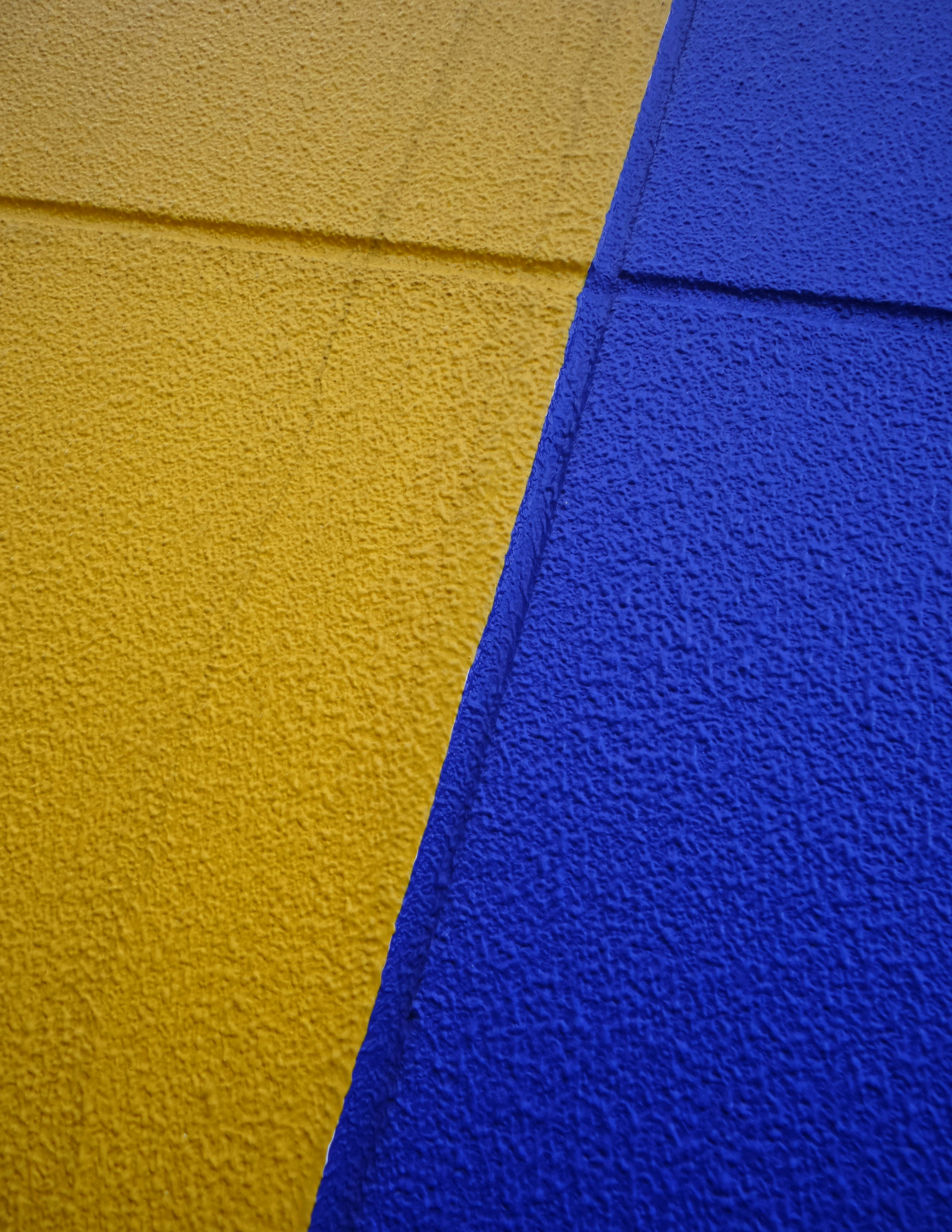 a yellow and blue wall with a phone on it