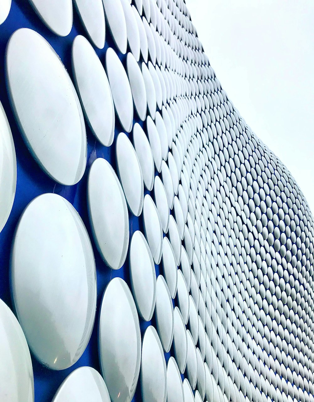 a close up of a building made of white and blue circles