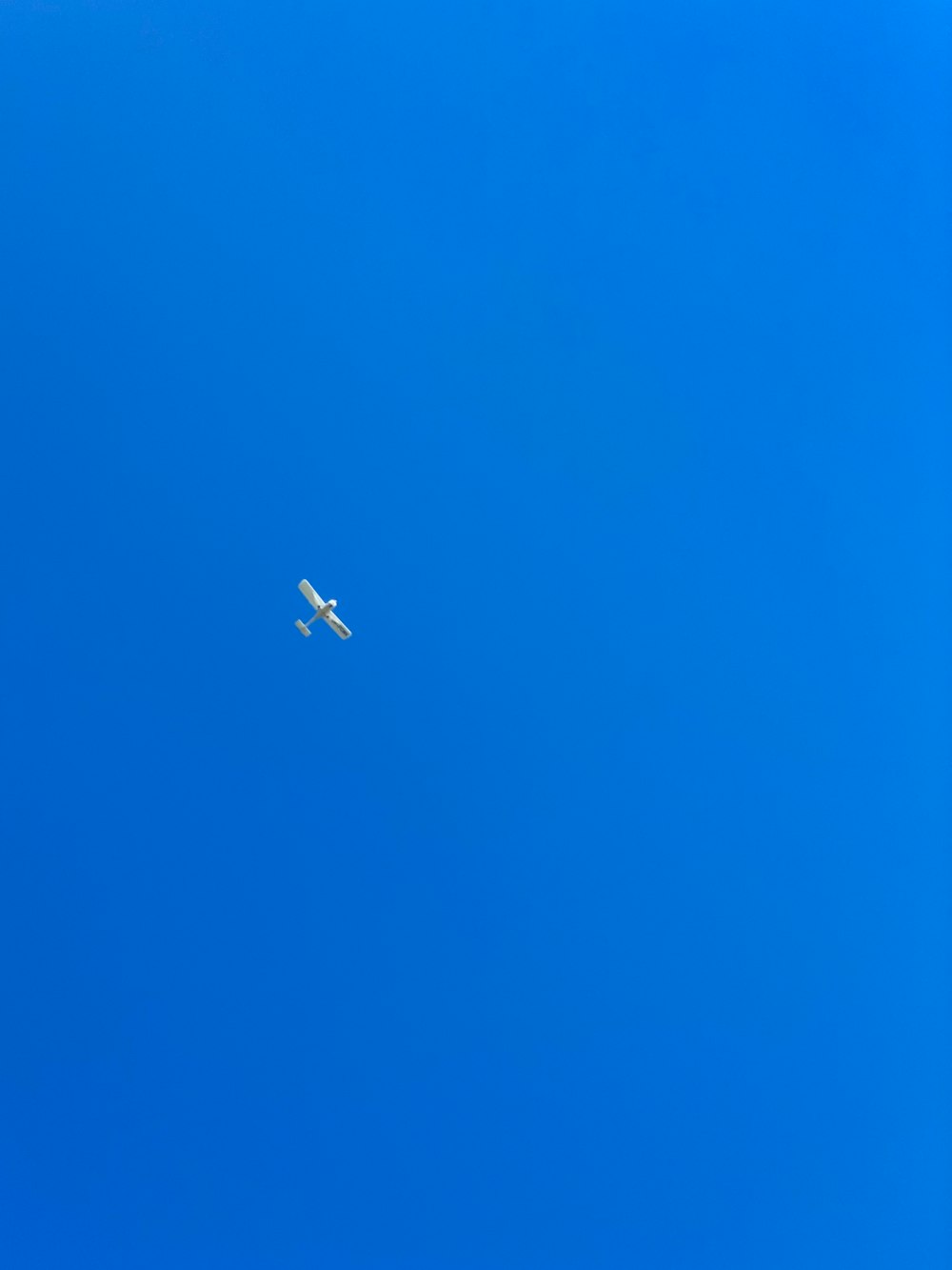 an airplane is flying high in the blue sky