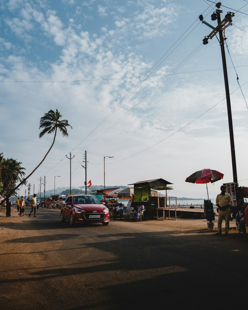 a group of people standing on the side of a road