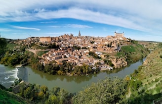 a river running through a small town surrounded by trees