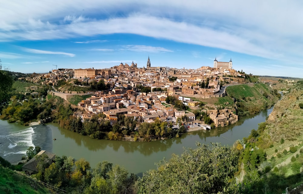 a river running through a small town surrounded by trees