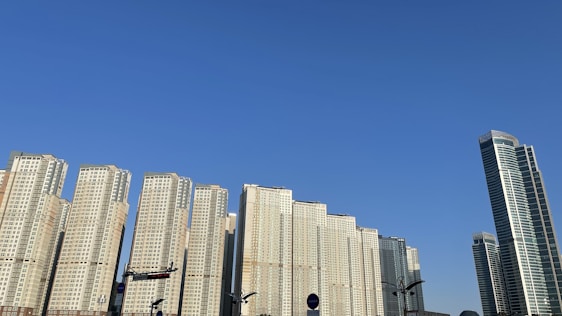 Modern residential buildings under clear sky in an urban neighborhood.