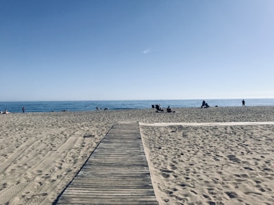A clean, blue sea with people enjoying public beach access.