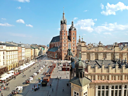 City square with a clock tower in Kraków, Poland, an old town setting for a first coffee date