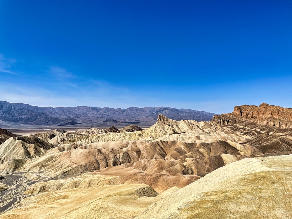 a view of a mountain range with a blue sky in the background