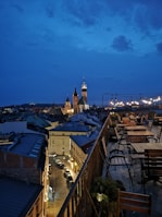 A cozy hotel terrace overlooking a lively cityscape at dusk
