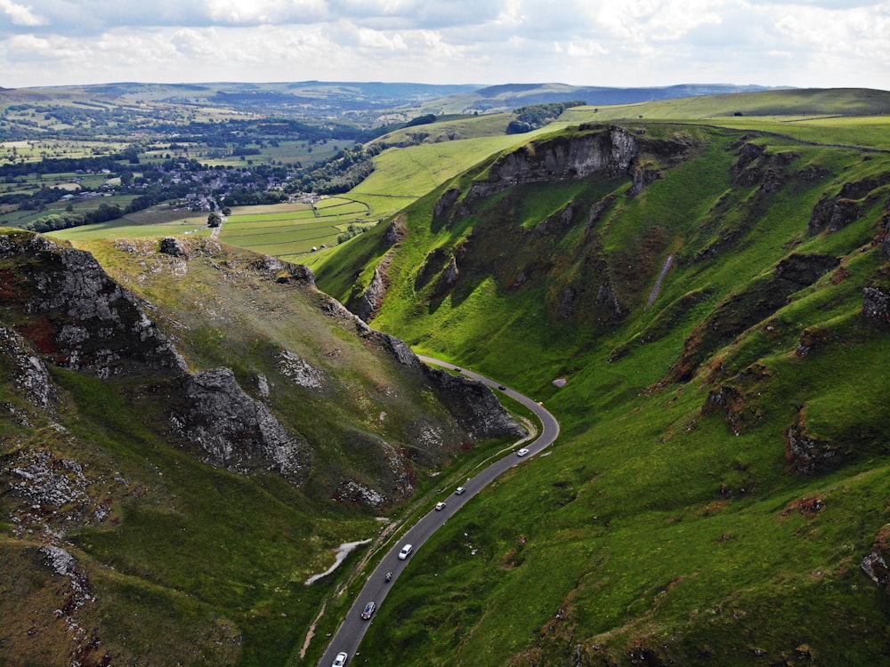 a car driving down a winding road in the mountains