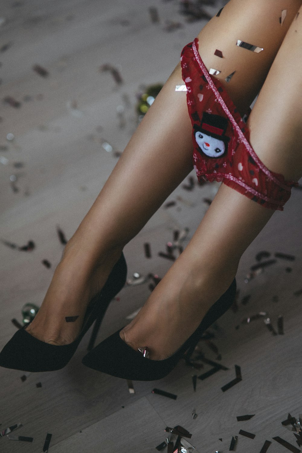 a close up of a person's legs wearing high heels
