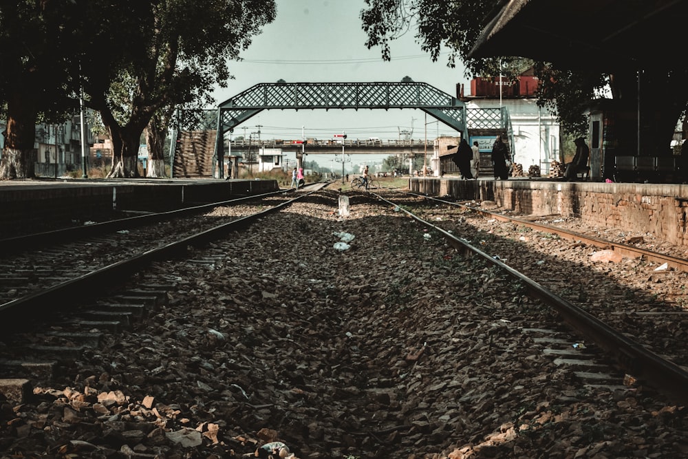 a train track with a bridge in the background