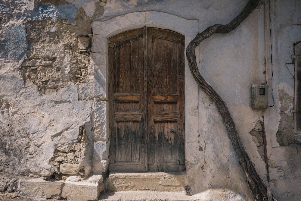 an old building with a wooden door and steps
