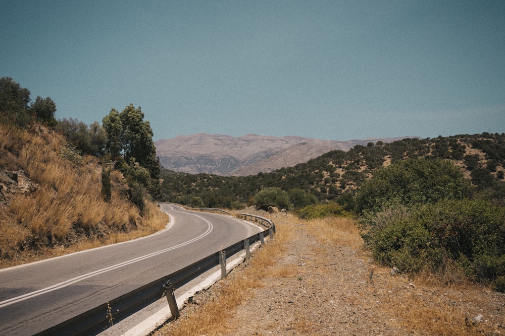 a road with a mountain in the background