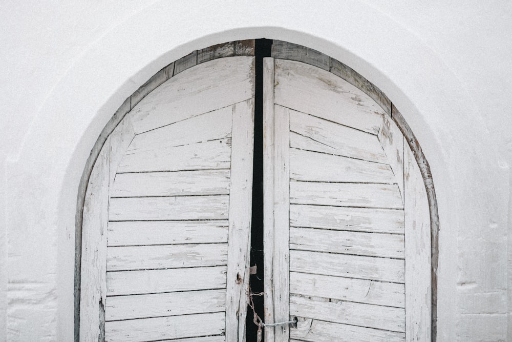 an open white door with a black handle