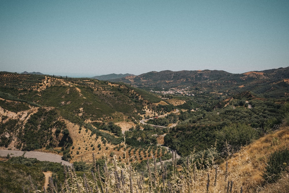 a scenic view of a mountain with a winding road