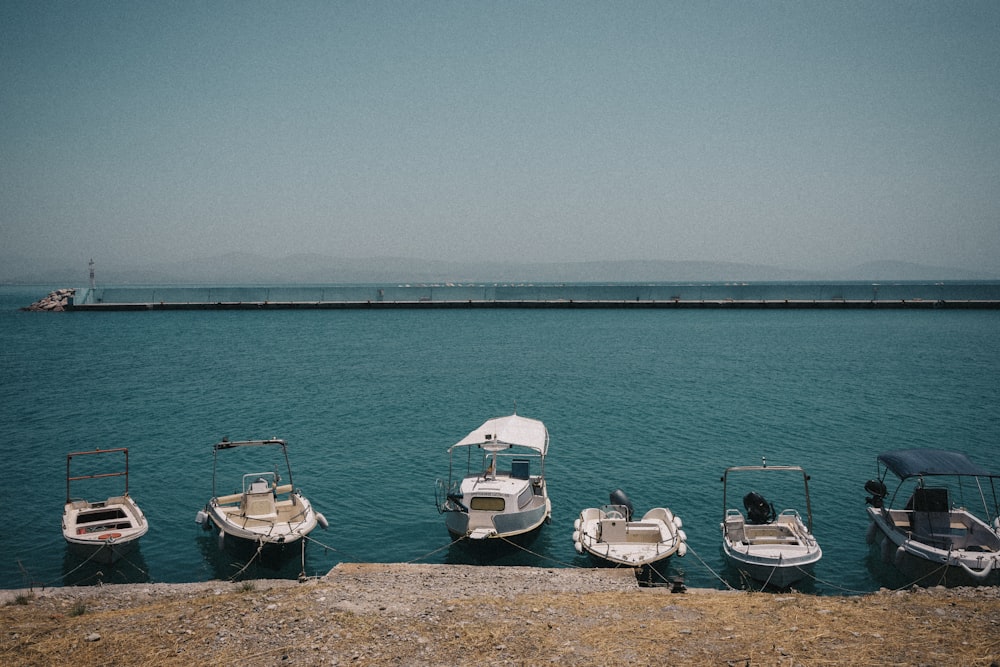 a group of small boats sitting on top of a body of water