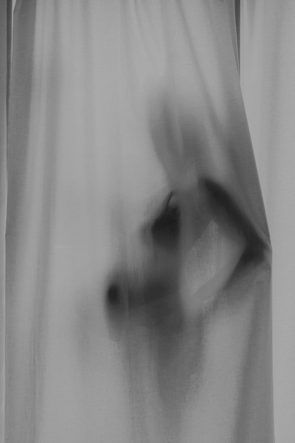 a blurry image of a person's hand coming out of a curtain