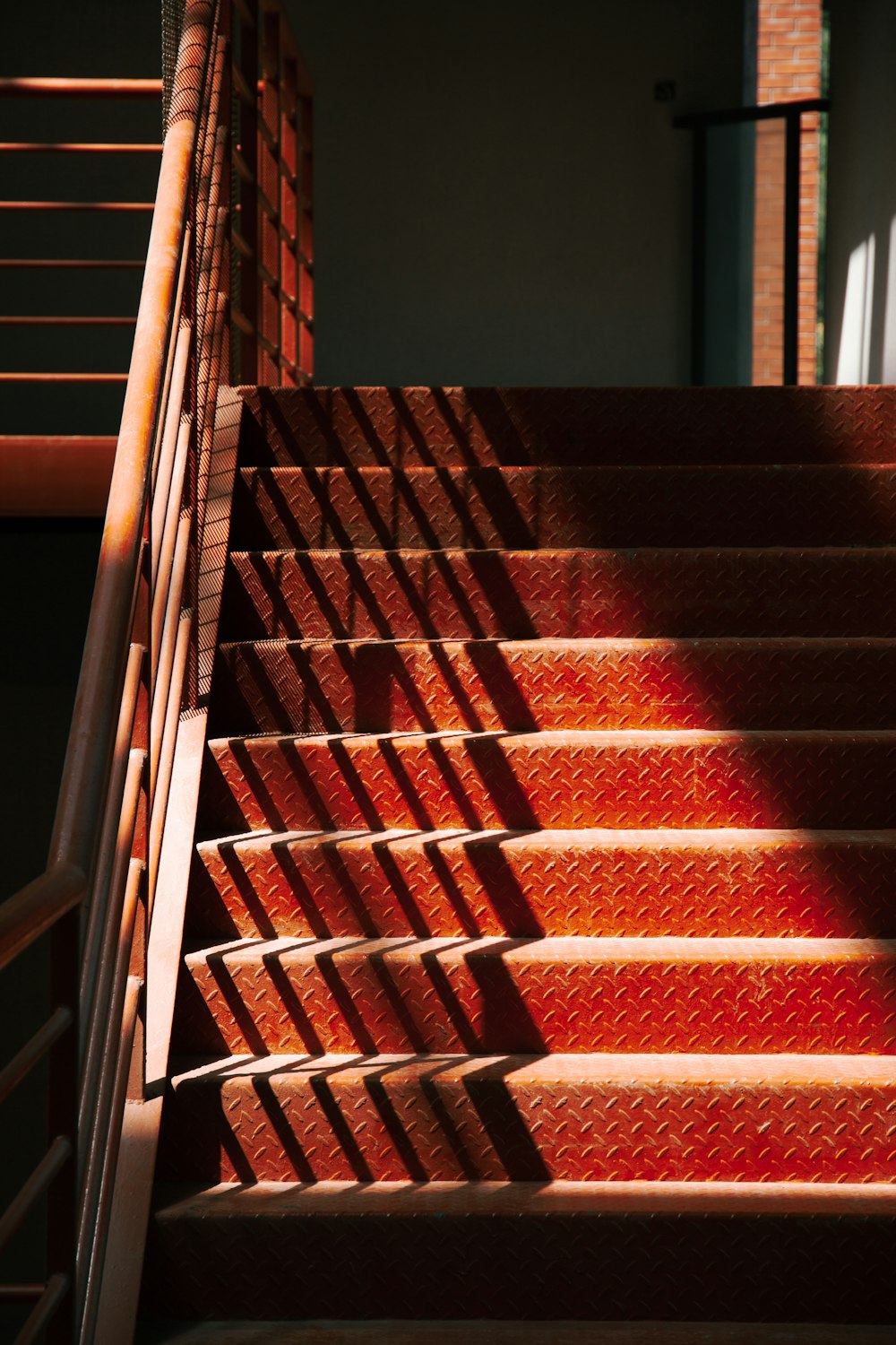 a close up of a set of stairs with red carpet