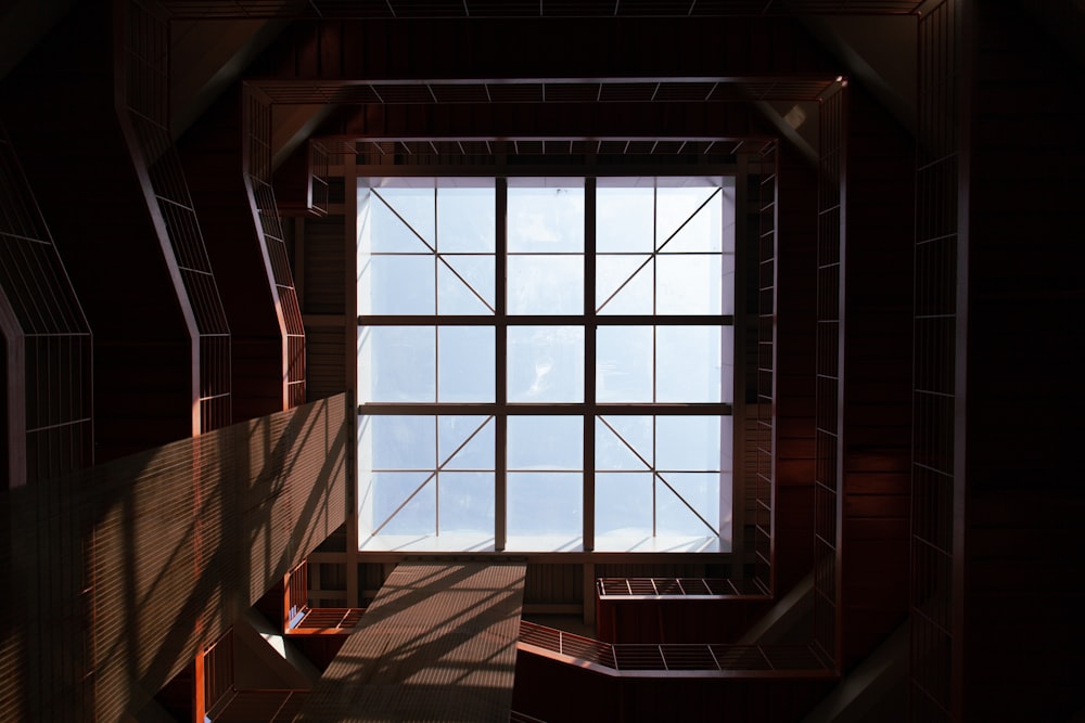 a room with a large window and some benches