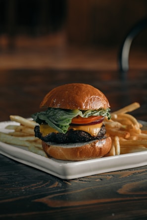 a cheeseburger and fries on a plate on a table