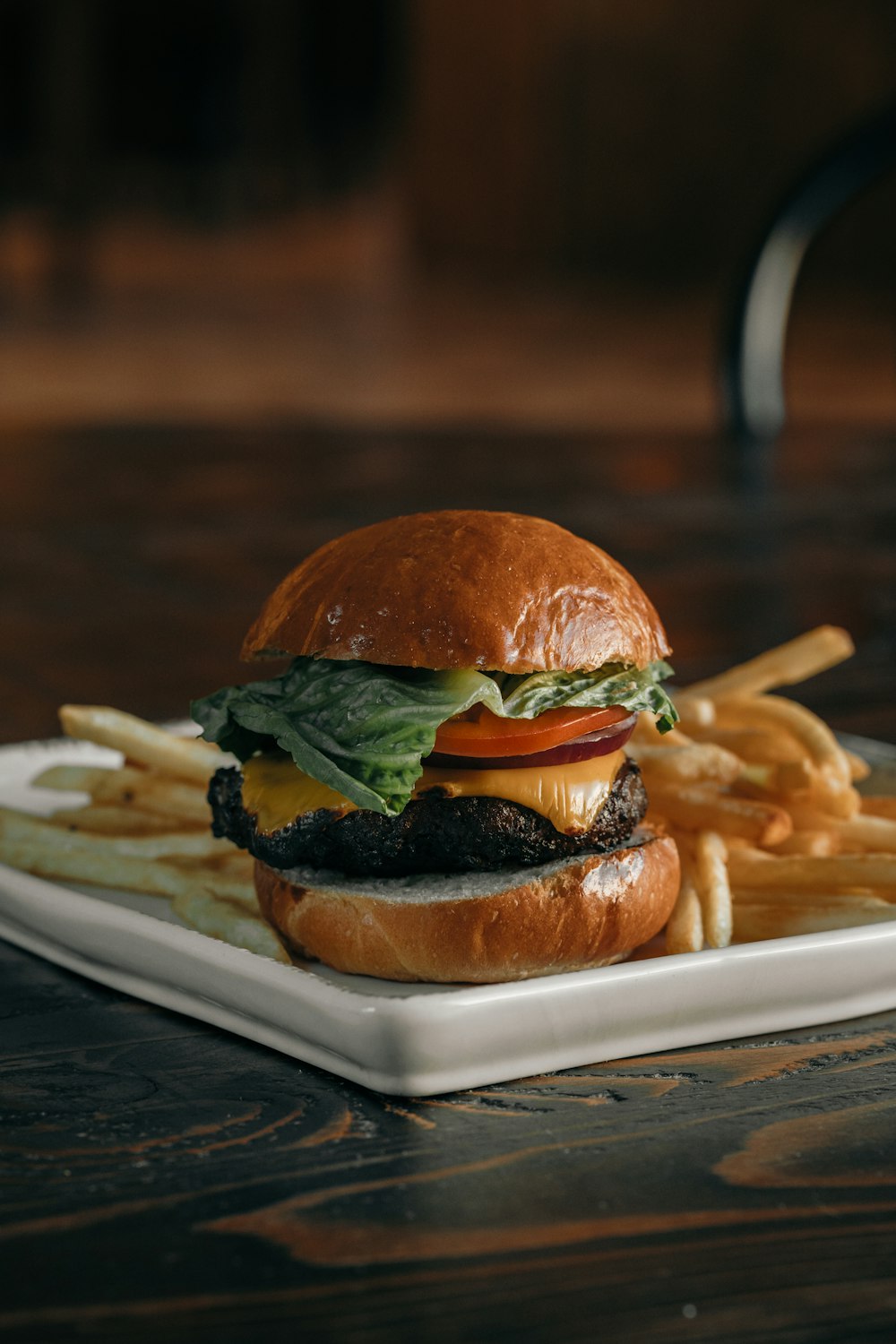 a cheeseburger and fries on a plate on a table