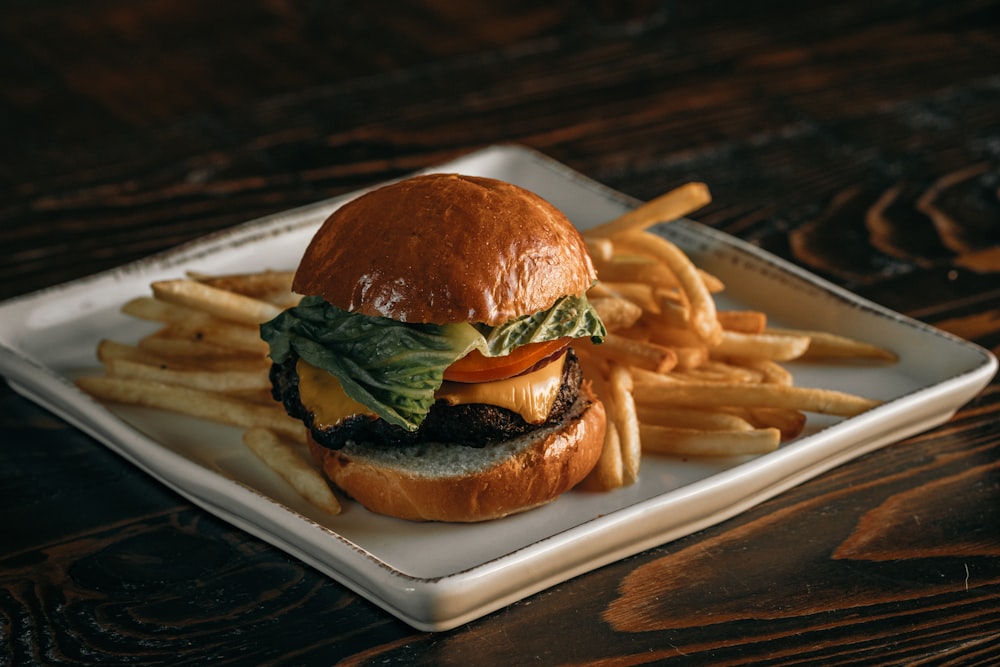 a cheeseburger and fries on a plate on a table