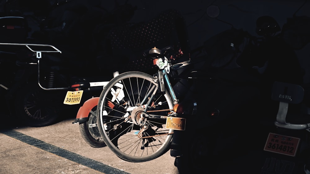 a bicycle parked next to a car in a parking lot