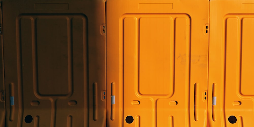 a row of yellow suitcases sitting next to each other
