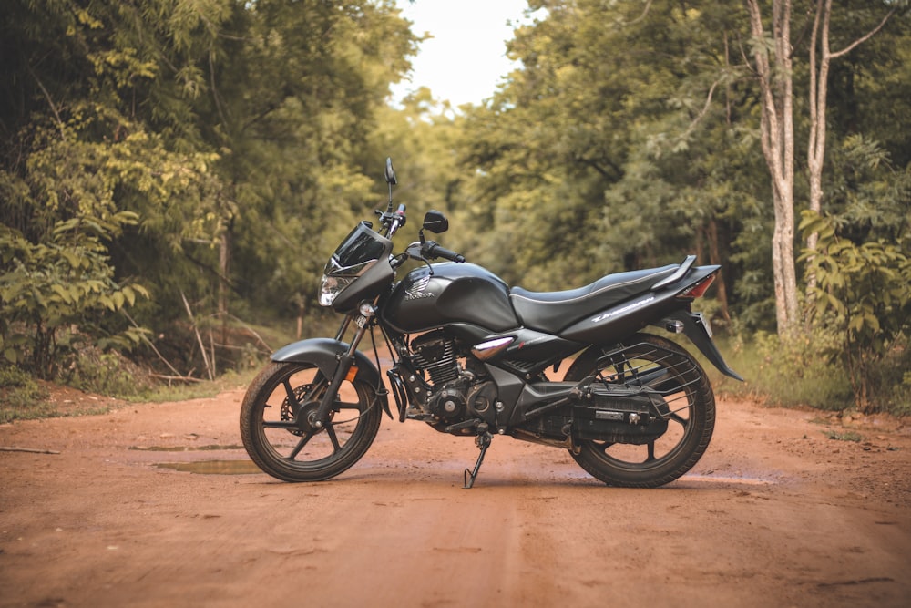 a motorcycle is parked on a dirt road