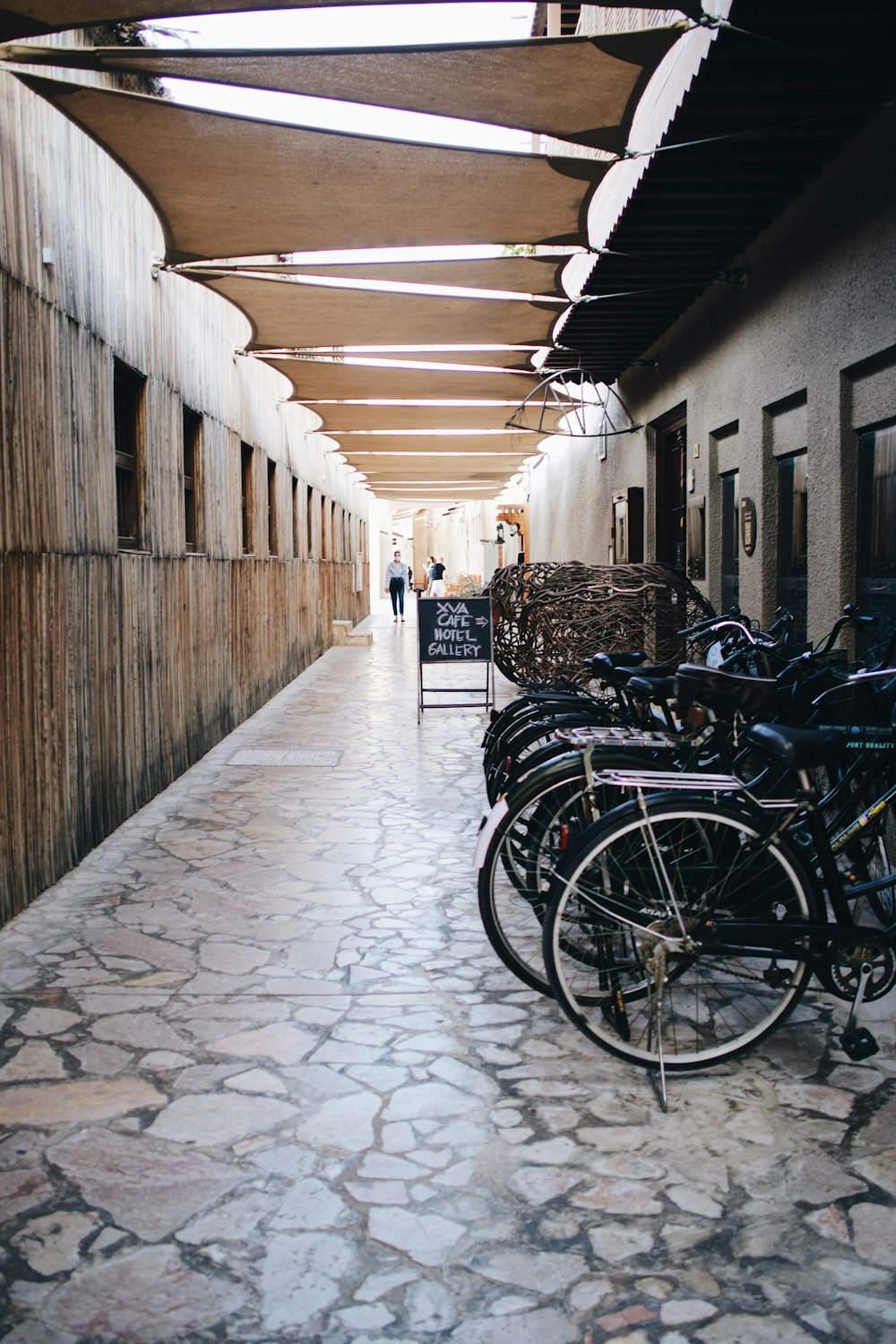 a long hallway with many bikes parked on the side of it