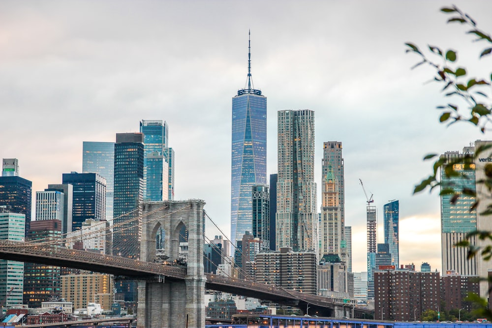 a view of a city skyline with a bridge in the foreground