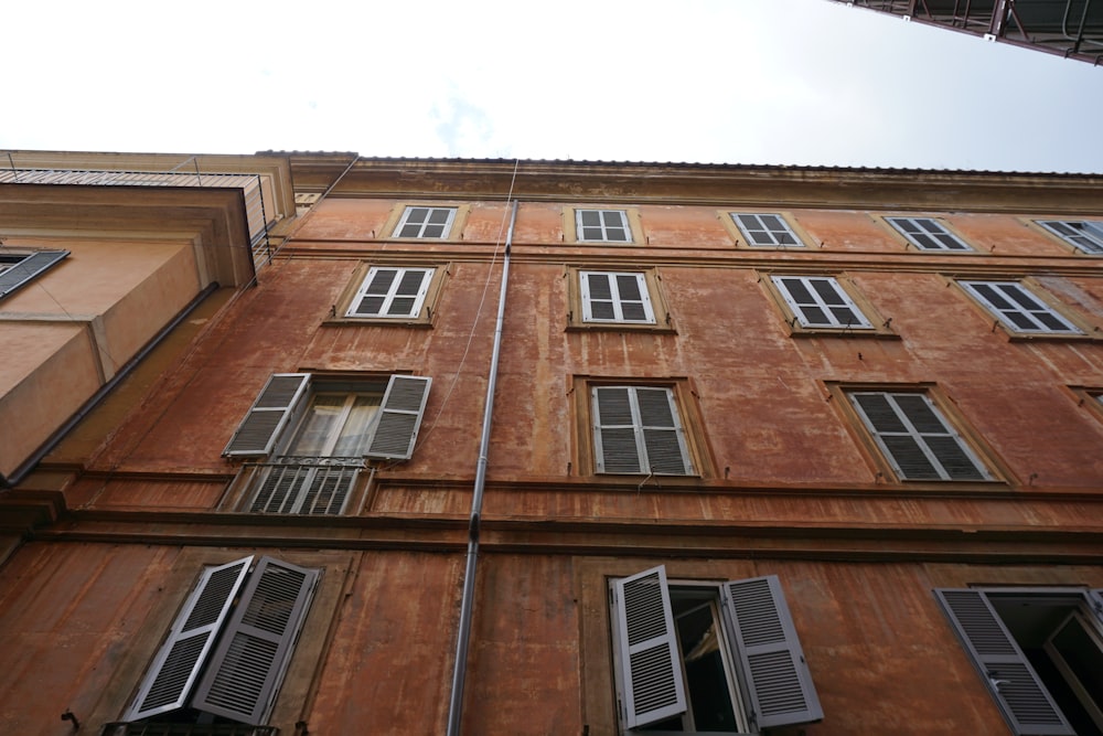 a tall building with lots of windows and shutters