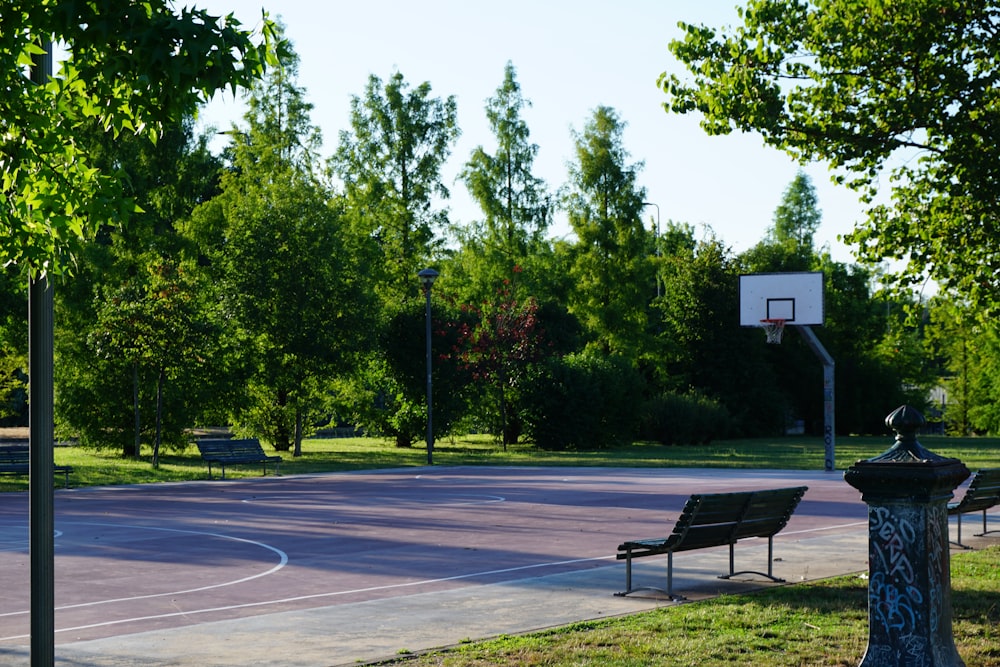 a basketball court with benches and a basketball hoop