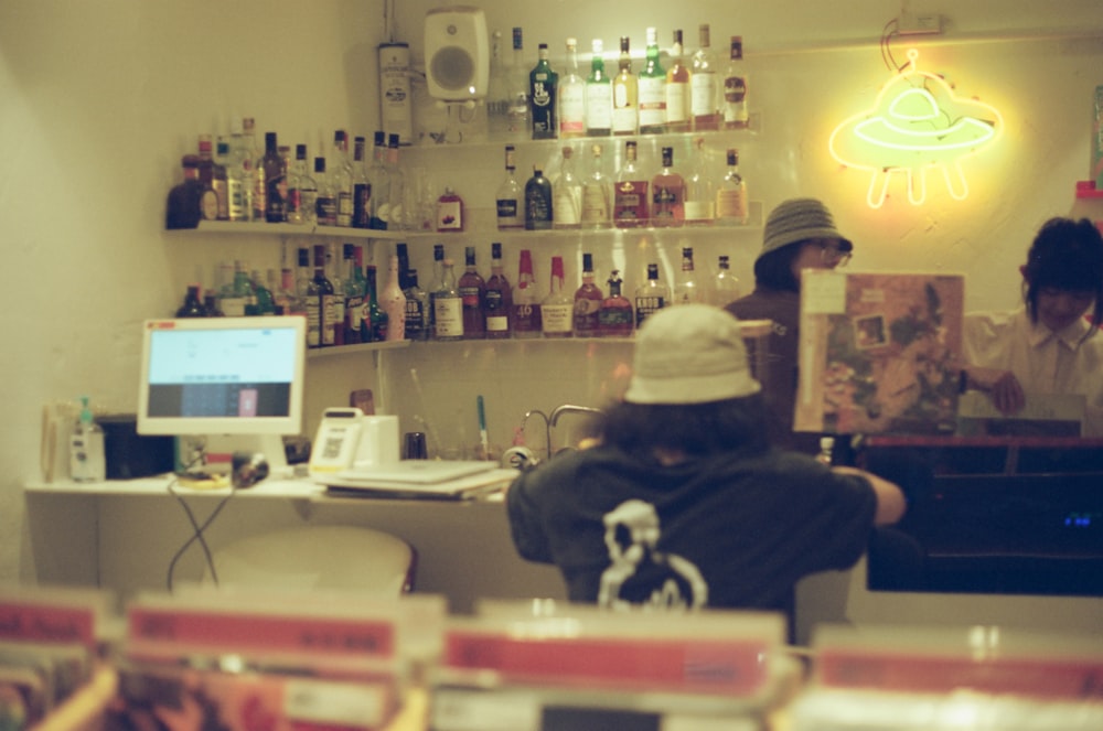 a person sitting at a counter with a laptop